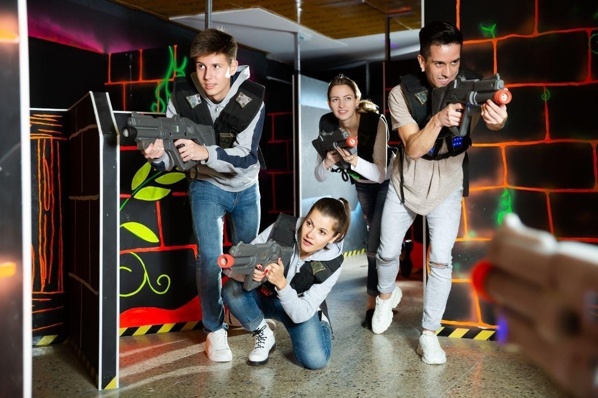Family playing laser tag at an indoor arena