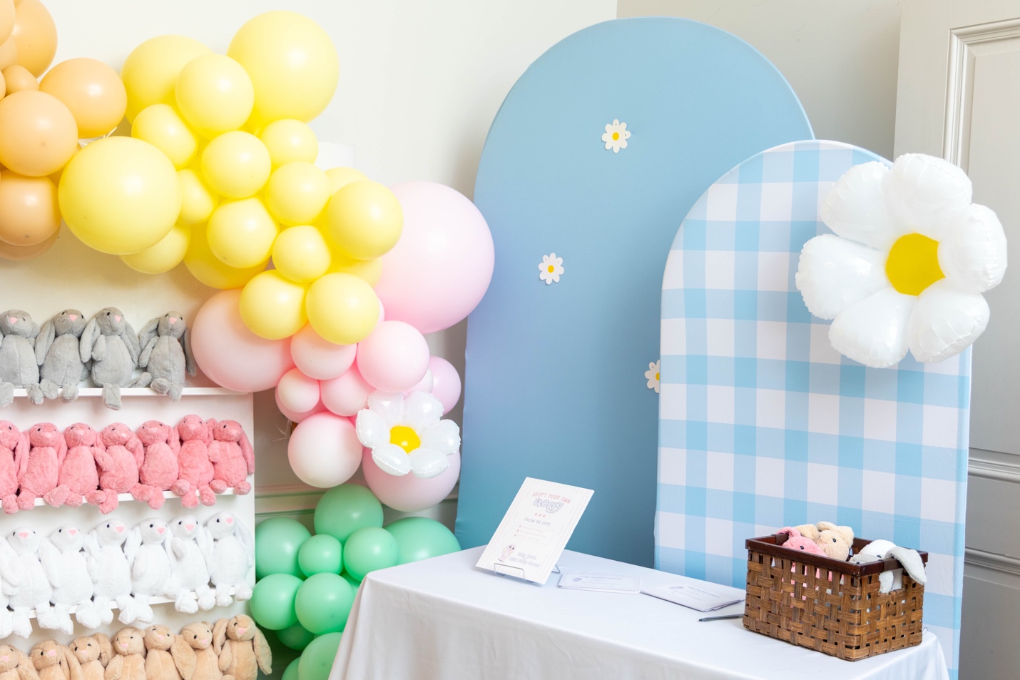 Adopt-a-Floppy station with shelves of plush bunnies in grey, pink, white, and beige